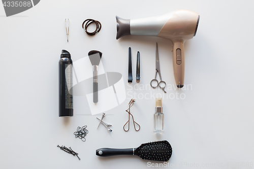 Image of hairdryer, scissors and other hair styling tools