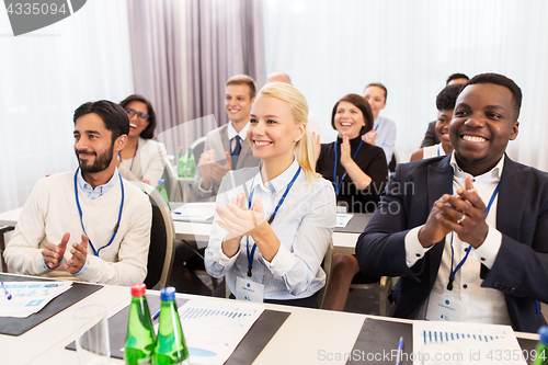 Image of people applauding at business conference