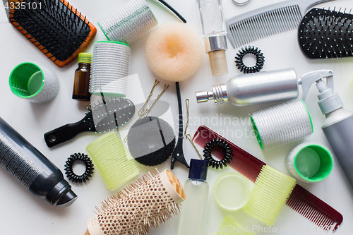 Image of hair brushes, styling sprays, curlers and pins