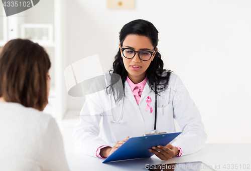 Image of doctor with pink awareness ribbon and patient