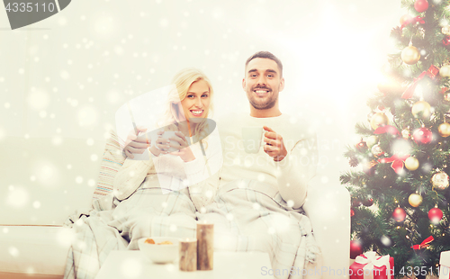 Image of happy couple at home with christmas tree