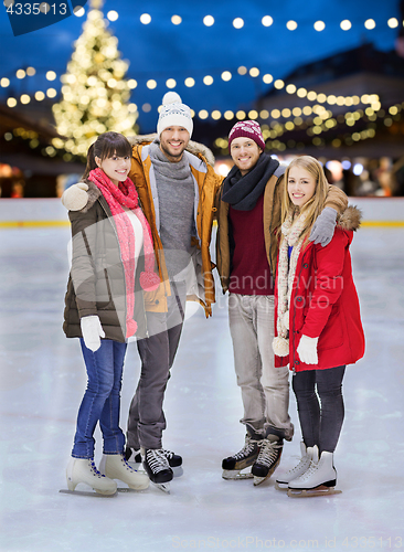 Image of happy friends at christmas skating rink