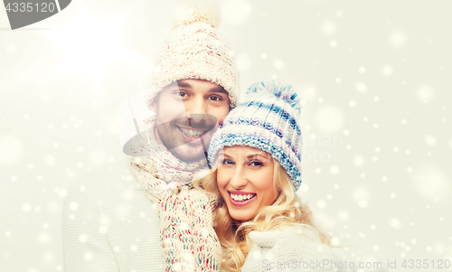 Image of smiling couple in winter clothes hugging