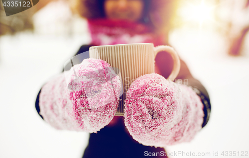 Image of close up of woman with tea mug outdoors in winter