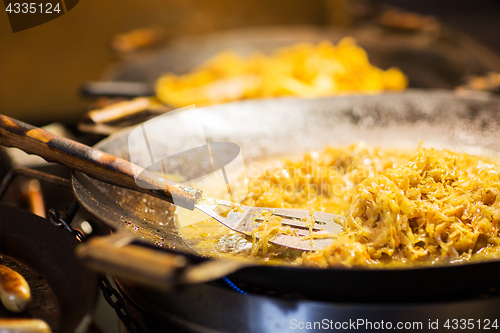 Image of braised cabbage or sauerkraut in wok or frying pan