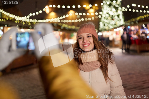 Image of happy woman posing for smartphone at christmas