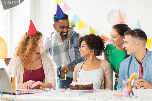 Image of team greeting colleague at office birthday party