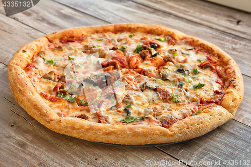 Image of Pizza On A Wooden Table