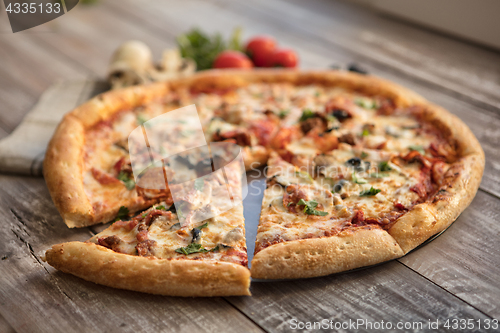 Image of Pizza On A Wooden Table