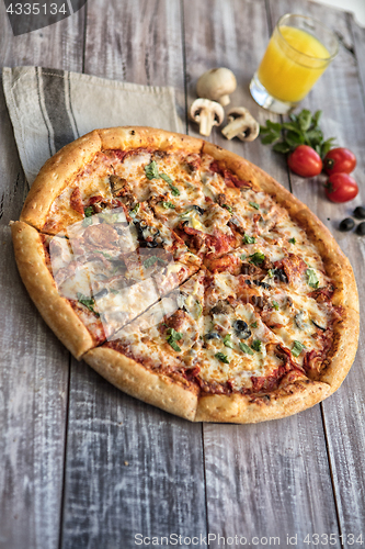 Image of Pizza On A Wooden Table