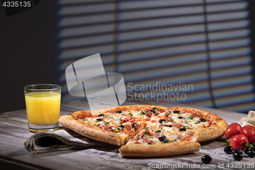 Image of Pizza On A Wooden Table