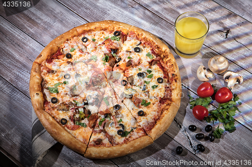 Image of Pizza On A Wooden Table