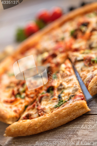 Image of Pizza On A Wooden Table