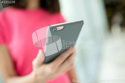 Image of Woman holding a phone