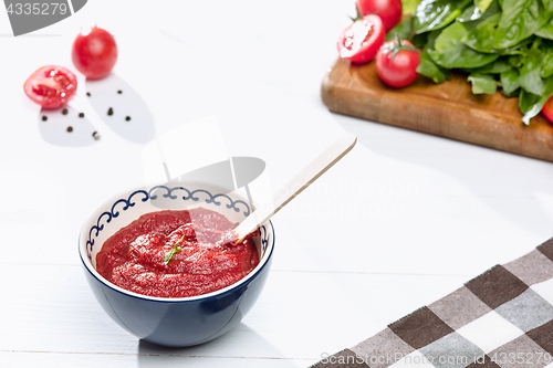 Image of Bowl of chopped tomatoes on rustic table