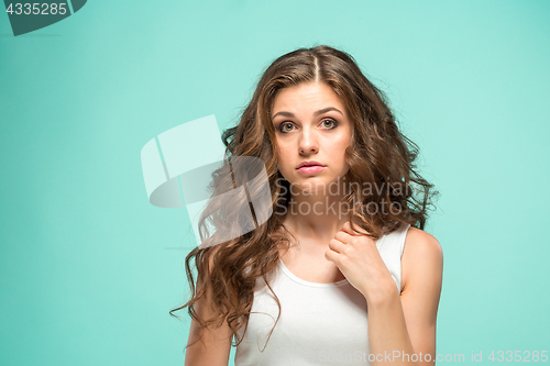 Image of Portrait of young woman with shocked facial expression