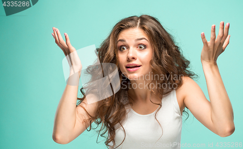 Image of Portrait of young woman with shocked facial expression