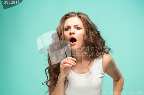 Image of Portrait of young woman with shocked facial expression