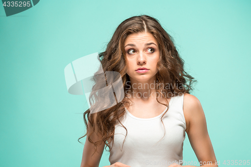 Image of Portrait of young woman with shocked facial expression