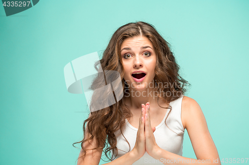 Image of Portrait of young woman with shocked facial expression