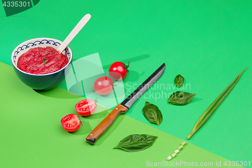 Image of Bowl of chopped tomatoes on green table