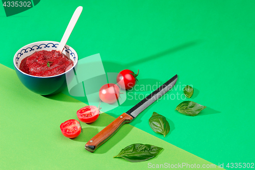 Image of Bowl of chopped tomatoes on green table
