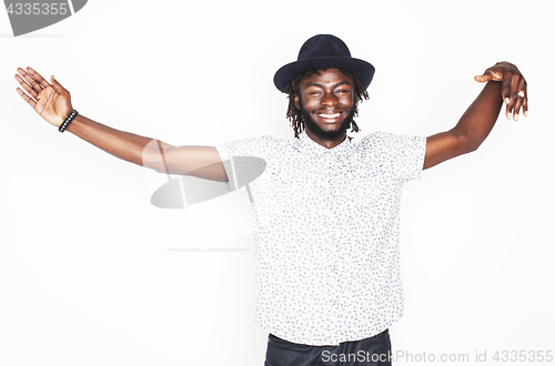 Image of young handsome afro american boy in stylish hipster hat gesturin