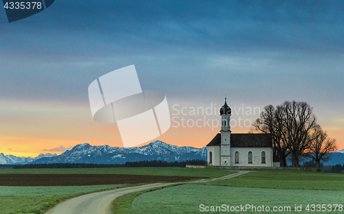 Image of Sunrise over old chapel in green field