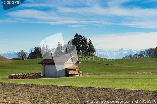 Image of Alpine mountains spring landscape with wooden shed