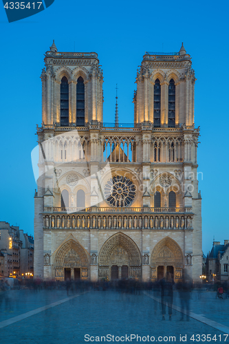 Image of Notre Dame Cathedral with Paris cityscape at dusk