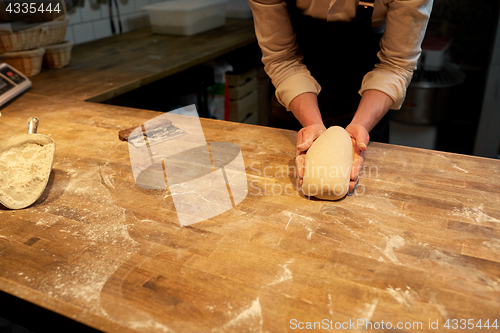 Image of chef or baker cooking dough at bakery