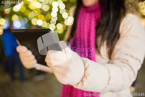 Image of close up of woman with tablet pc at christmas