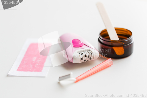 Image of safety razor, epilator, hair removal wax and patch