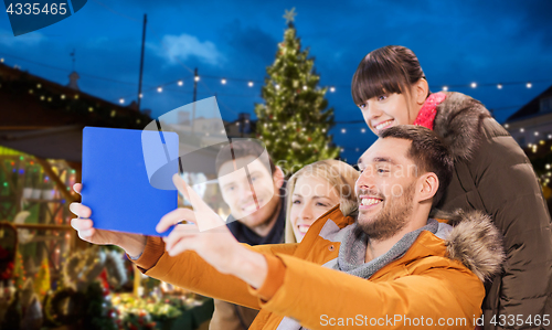 Image of friends with tablet pc taking christmas selfie