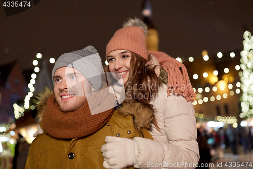 Image of happy couple hugging at christmas market