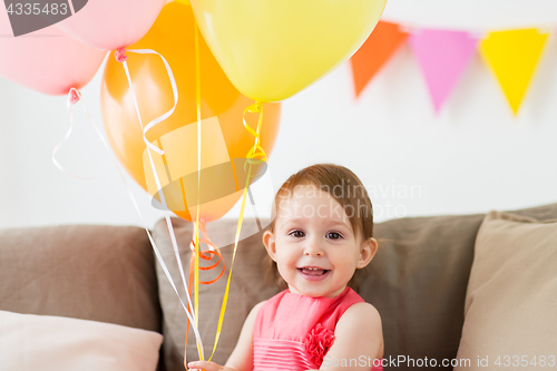 Image of happy baby girl on birthday party at home