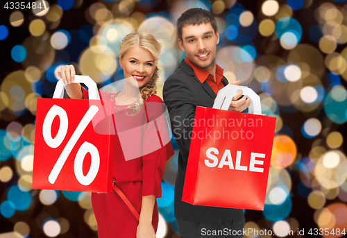 Image of couple with sale and discount sign on shopping bag