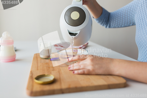 Image of mother pouring water into bowl for baby cereal