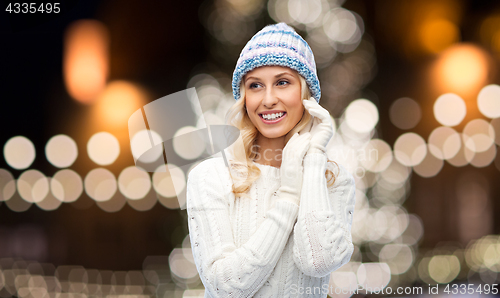 Image of happy woman over christmas lights