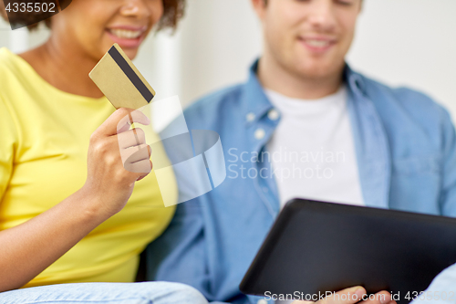 Image of couple with tablet pc and credit card