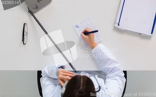 Image of doctor with prescription calling on phone