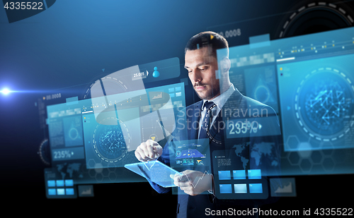 Image of businessman in suit with transparent tablet pc