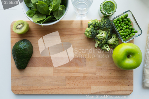 Image of vegetable puree or baby food and fruits on board