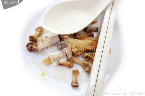 Image of Chicken bones on a white plate