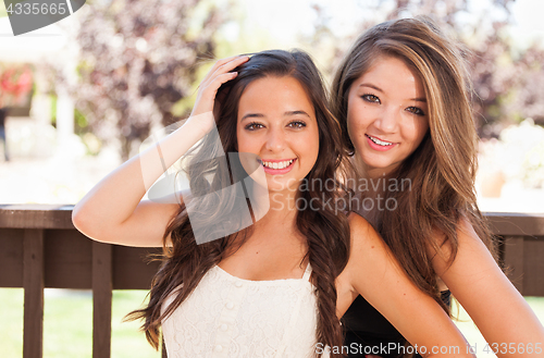 Image of Two Mixed Race Girlfriends Pose for Portrait Outdoors