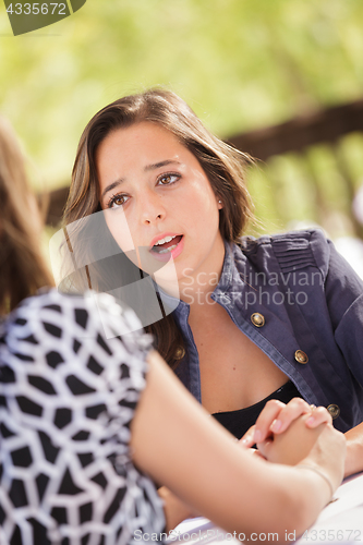 Image of Concerned Young Adult Woman Talking With Her Friend