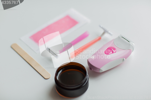 Image of hair removal wax, epilator and safety razor