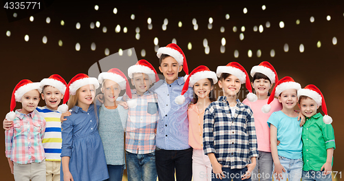 Image of happy smiling children in christmas santa hats