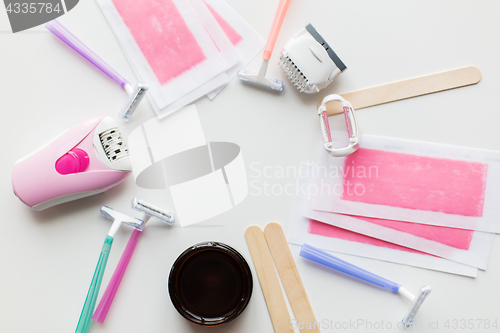 Image of hair removal wax, epilator and safety razor