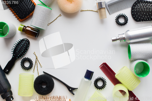 Image of hair brushes, styling sprays, curlers and pins